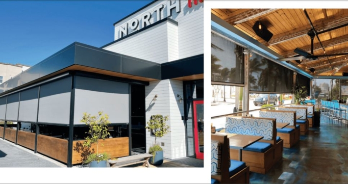 Exterior view of a Restaurant with a retractable Magna track screen installed outside in Austin, TX